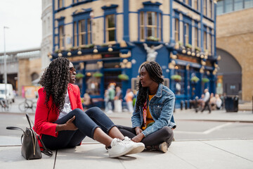 Women sitting on a bench in the city in their free time