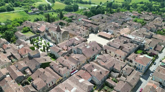 Monpazier  town France pull back drone aerial reverse reveal