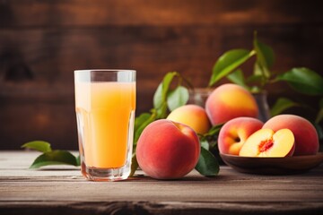 Fototapeta premium Peach juice in glass on rustic wooden table top, close up view.
