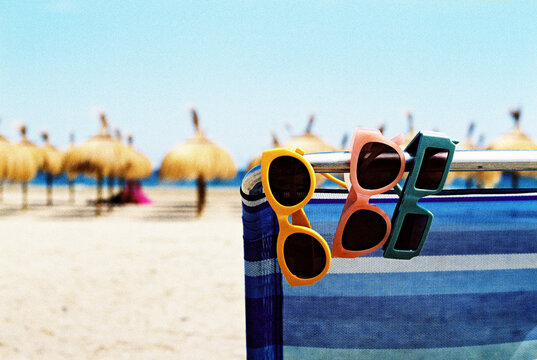 colorful sunglasses in a beach chair, 35 mm film