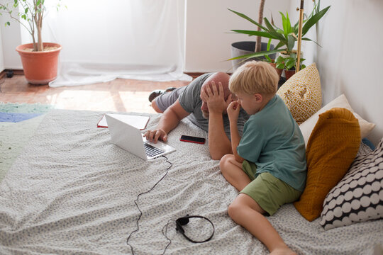 father and son with laptop