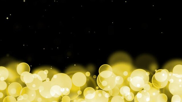 Circle bubles glow yellow slow motion random size with falling white stars on the black background