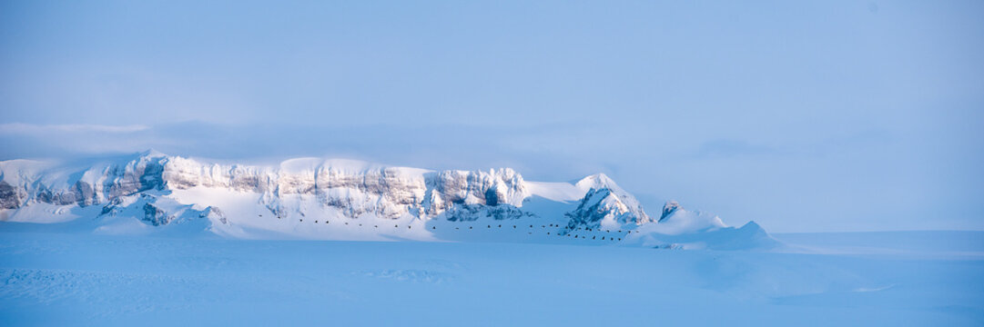 Snow covered mountain range and glacier in Iceland
