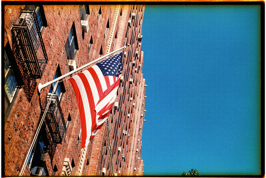 american flag hangs in a brick building in New York, 35 mm