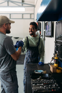 Two Men Working in Car Garage 
