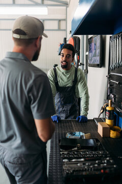Two Men Working in Car Garage 