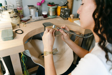 young woman focused on Working on a piece of jewellery 