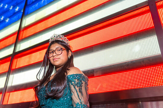 Portrait Of A Fifteenth Birthday Quinceanera With The USA Flag.