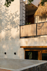 A concrete modern beach house with a bamboo balcony 