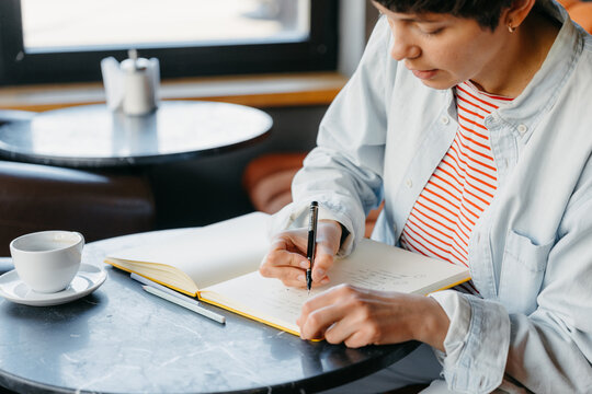 A woman makes notes in a notebook