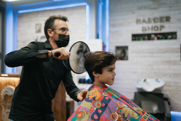 Barber Shows Child's Haircut to Ensure Satisfaction