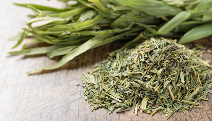 Dry and fresh tarragon on table, closeup