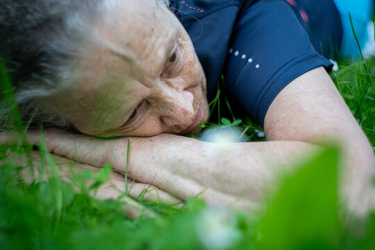 Senior woman lying on grass