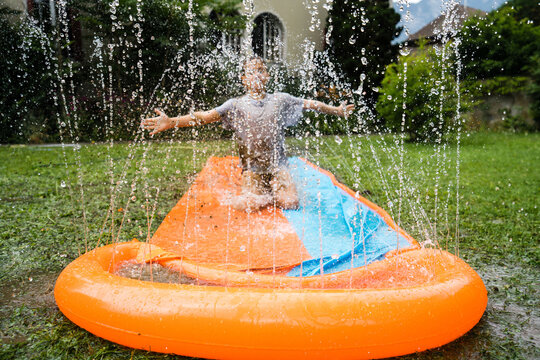 Boy sliding on slip 'n slide