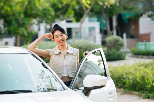 Beautiful Young Asian Woman Standing Next To Her Car And Smiling