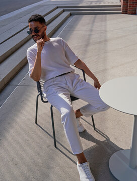 Stylish guy sitting in a city caf&eacute;