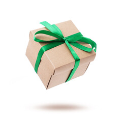 Object elegant beige gift box with green ribbon bow falling, flying in air with shadow Isolated