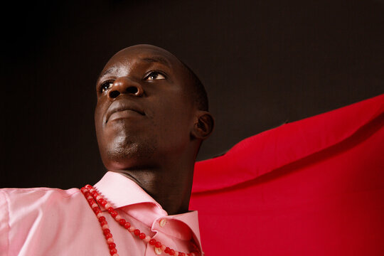 Young black man wearing pink posing at the studio