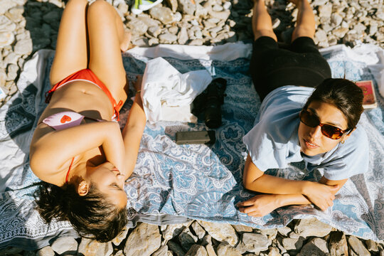 Friends Lounging on Rocky Beach