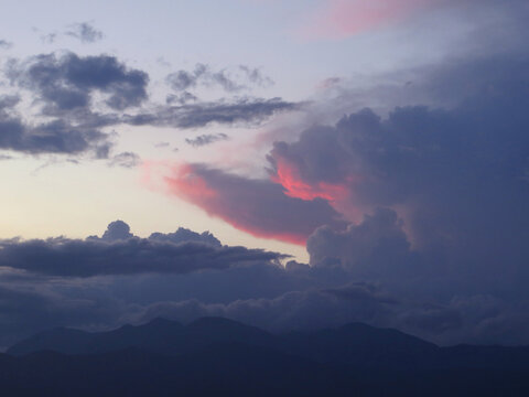 dramatic violet and red clouds in the sky at sunset