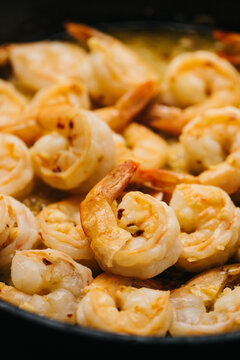 Butter-fried shrimp in a skillet