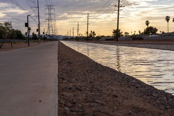 Chandler Arizona Canal at sunset powerlines and telephone poles in background - obrazy, fototapety, plakaty