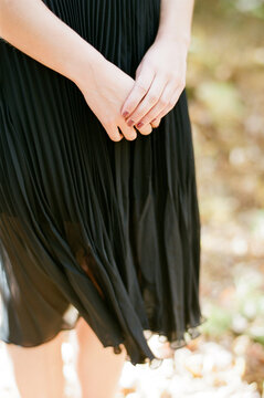 close up of woman in dress holding her hands