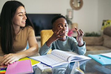 Little boy counting with his fingers while doing his math homework