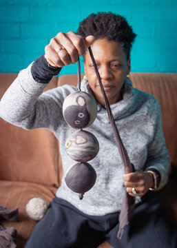 Woman holding a stocking stuffed with 3 handmade dryer balls