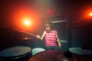 Excited drummer playing at music concert