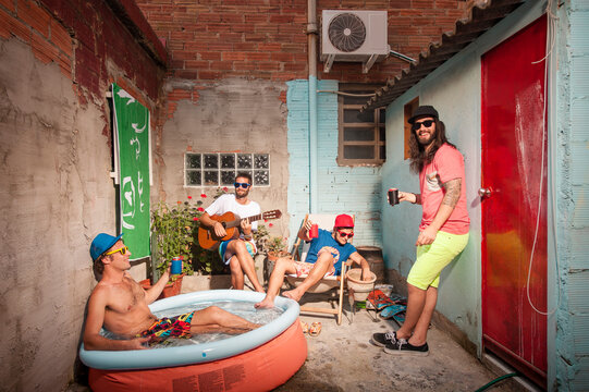 Friends having fun during summer at urban patio