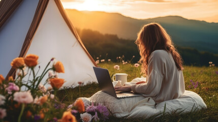 outdoor business office beside camping tent on businesswoman holiday.