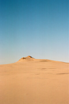 Landscape of dunes against a clear sky. 