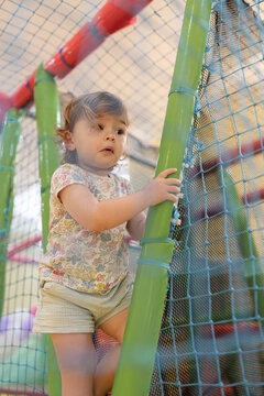 Little girl exploring playground.