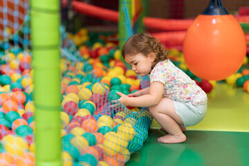 Child playing with plastic balls.