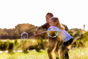 Siblings playing in park