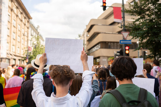 Anonymous Person Holding Protest Sign At Pride Parade