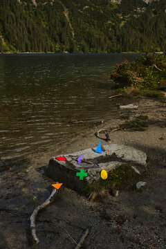 Conceptual still life with figures of rainbow colors in nature