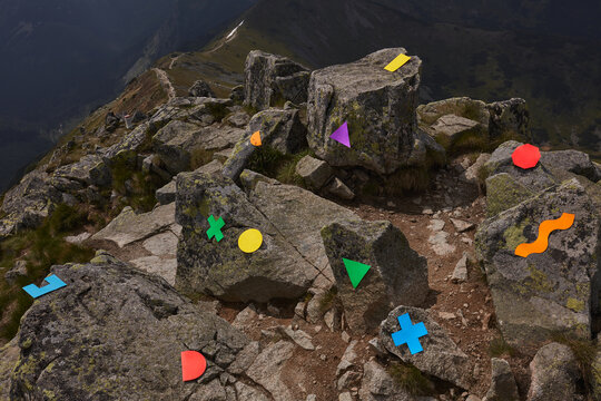 conceptual still life with multicolored figures in the mountains