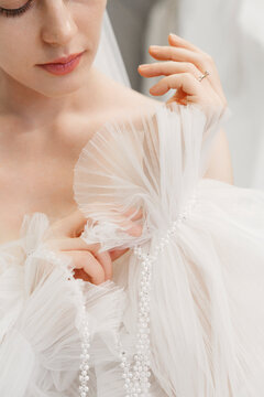 Young elegant bride in wedding dress in room