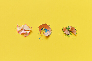 Shavings from pink, blue and green pencils.