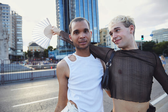 
Two queer friends embrace each other  during a  pride event