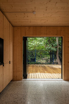 Interior of a room in a wooden house with a large patio door 