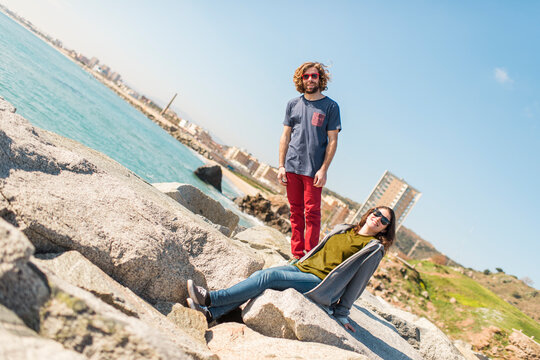 Surreal portrait of cheerful friends playing with gravity