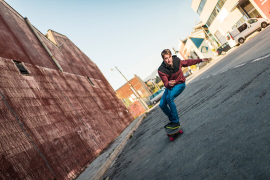 Surreal skater riding on leaning street