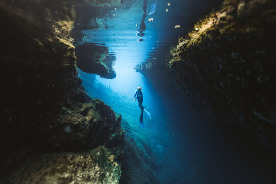freediver ascending from a cave