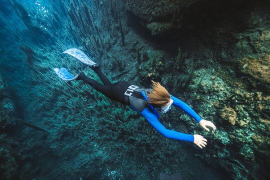 young diver above underwater plants 