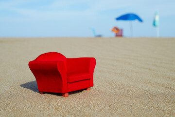 red toy armchair on the beach