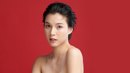 Obraz premium Beautiful young asian woman with clean fresh skin on red background, Face care, Facial treatment, Cosmetology, beauty and spa, Asian women portrait.