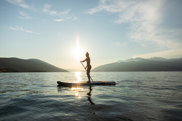 Woman on SUP paddle board 